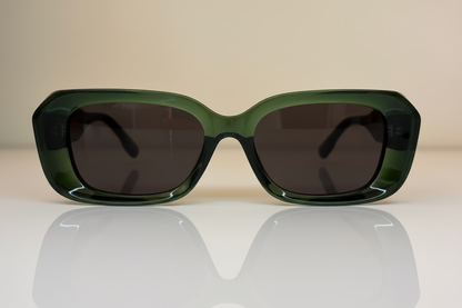 Green sunglasses with dark lenses on rectangular shape